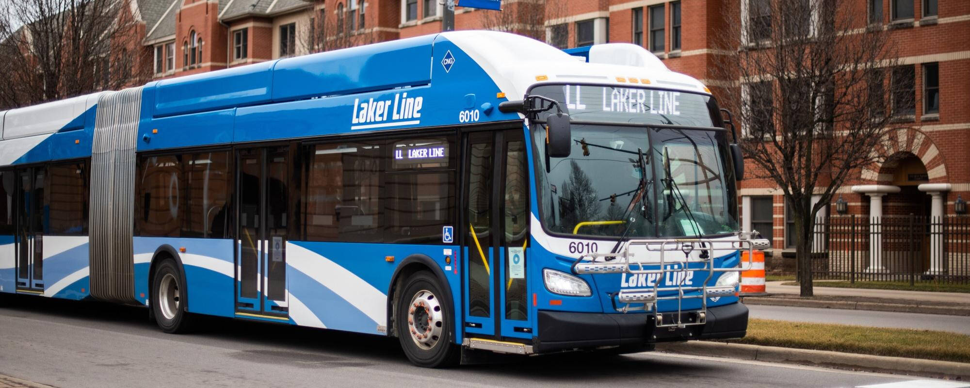blue bus parked in front of the bus stop in grand rapids